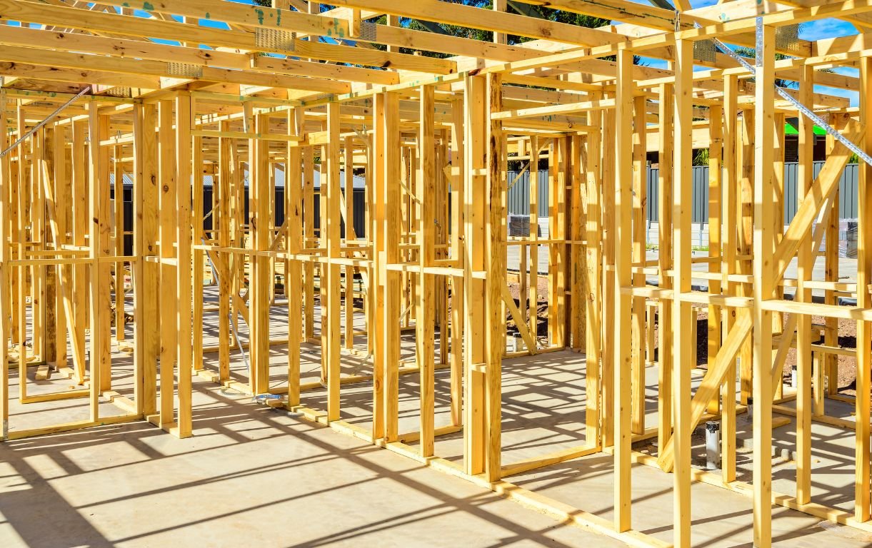 Timber roof trusses and wall frames of a house under construction