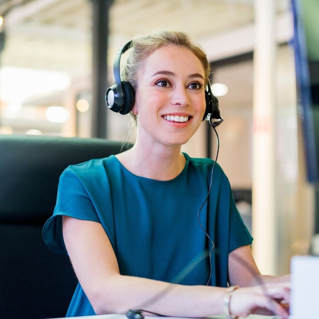 A customer service consultant wearing a headset, smiling